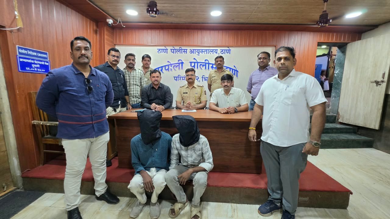 Narpoli police officers with the two arrested accused, faces covered, at a press conference in Bhiwandi